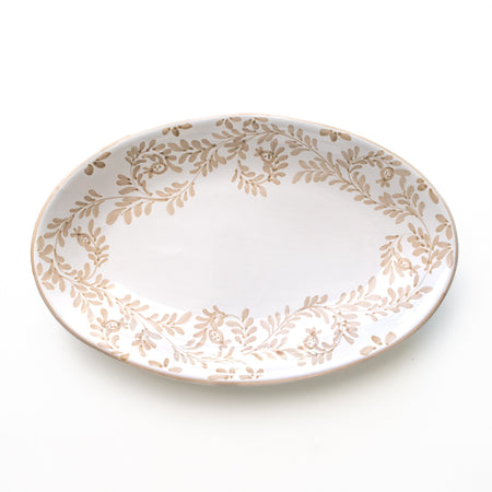 Decorative plate with gold leaf pattern on a white background