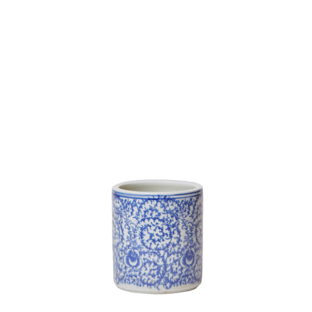 Ceramic cup with blue floral pattern on a gray background