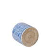 Cylindrical ceramic object with blue floral patterns on a white background