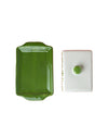 Green rectangular dish and white square dish with green knob on a white background