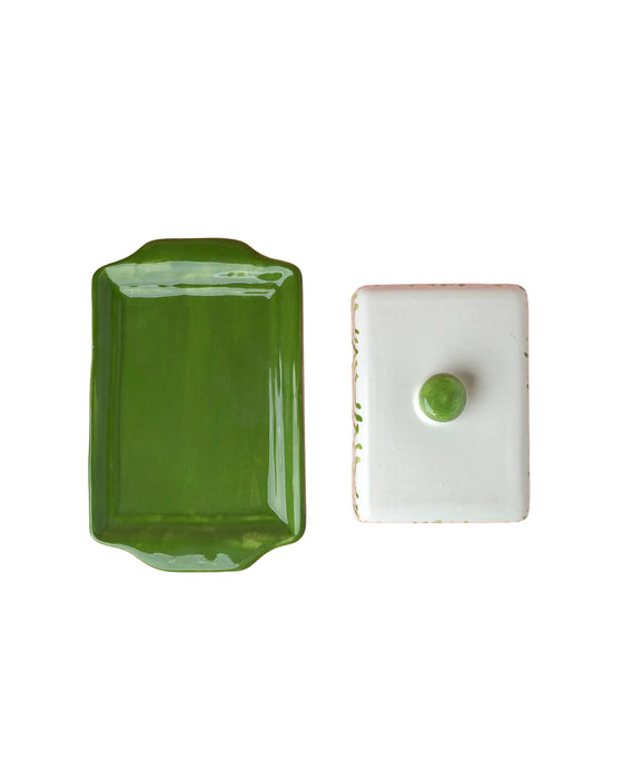 Green rectangular dish and white square dish with green knob on a white background