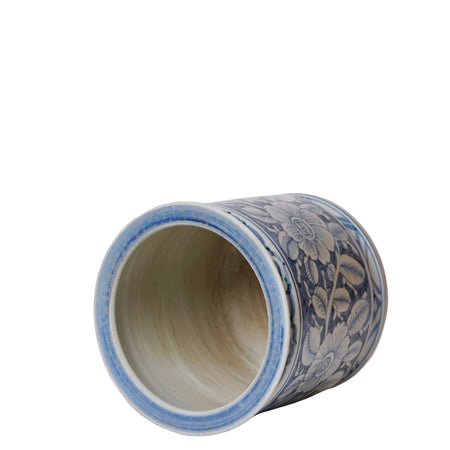 Cylindrical ceramic vase with blue floral patterns on a white background