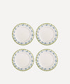 Set of four white plates with green floral rims on a white background