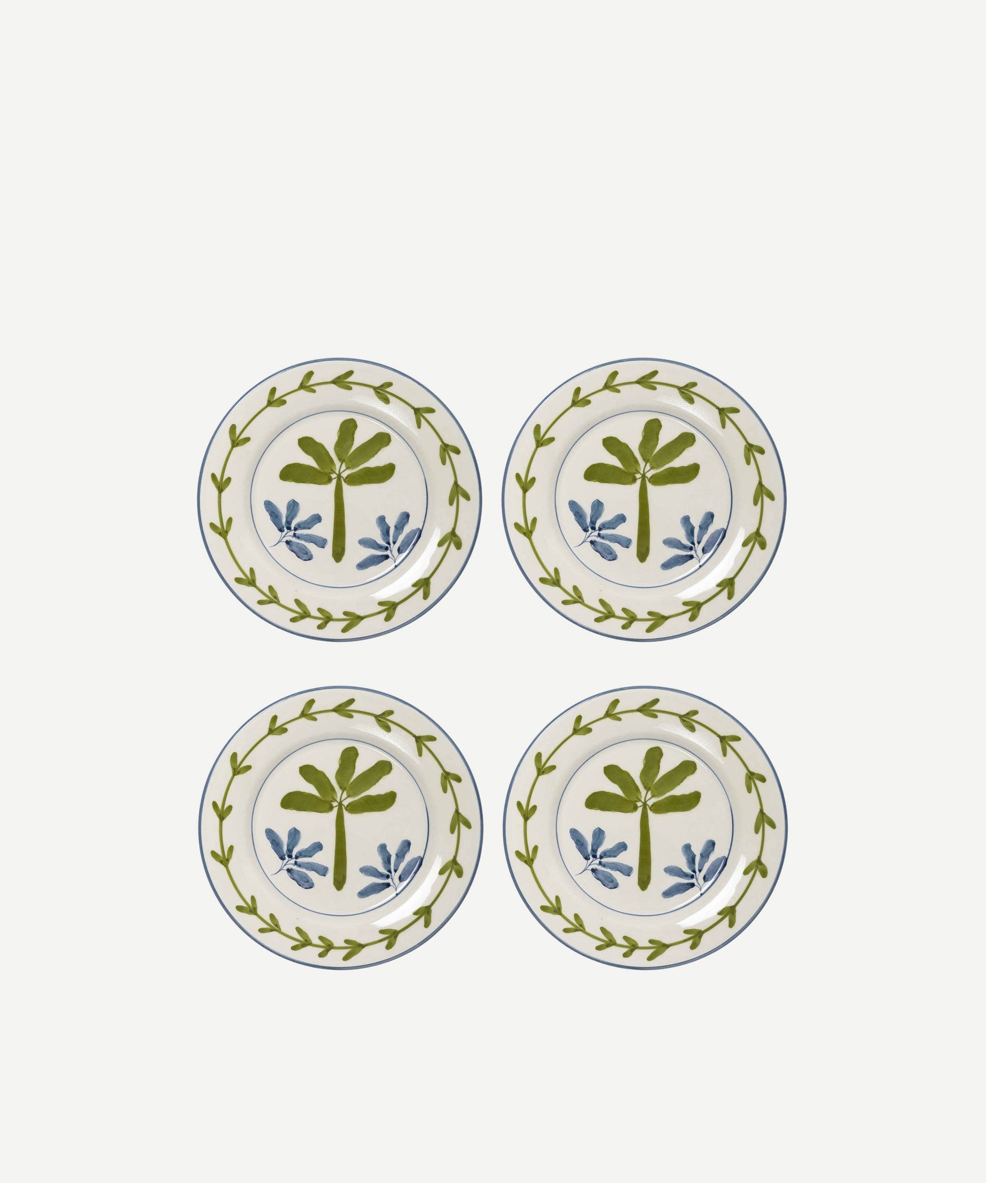 Four decorative plates with leaf patterns on a white background