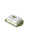 Butter dish with green lid and base on a pink background