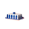 Butter dish with blue and white striped design on a pink background