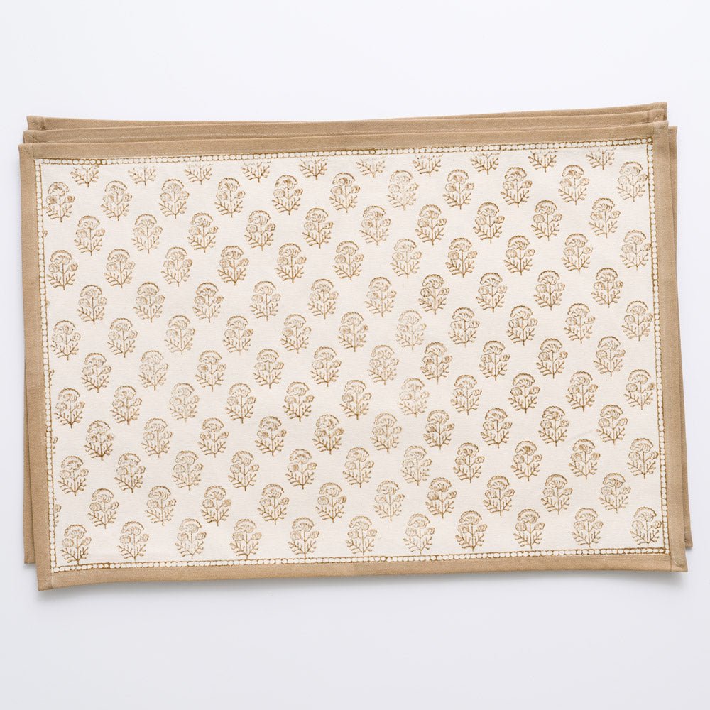 Beige floral design placemats on white background