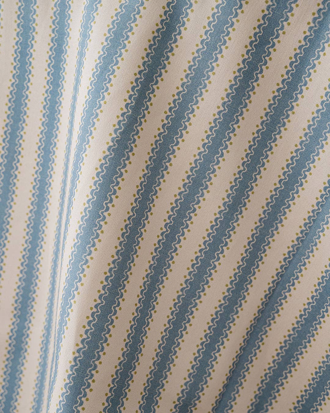 Fabric with blue diagonal stripes on a beige background