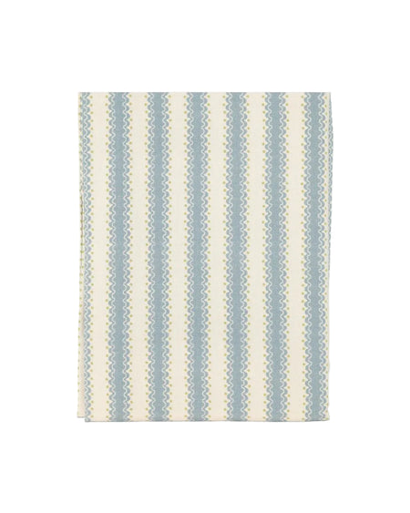 Striped rug with blue and beige pattern on a light gray background