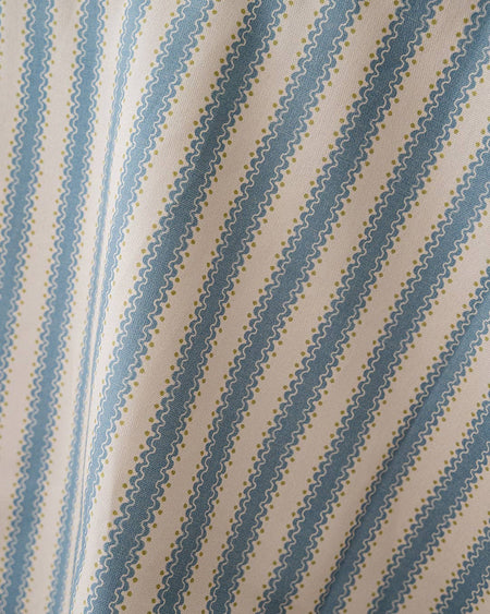 Fabric with blue diagonal stripes on a beige background