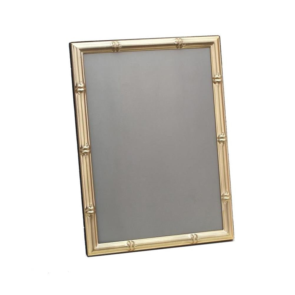 Picture frame with matte gold bamboo trim on white background 
