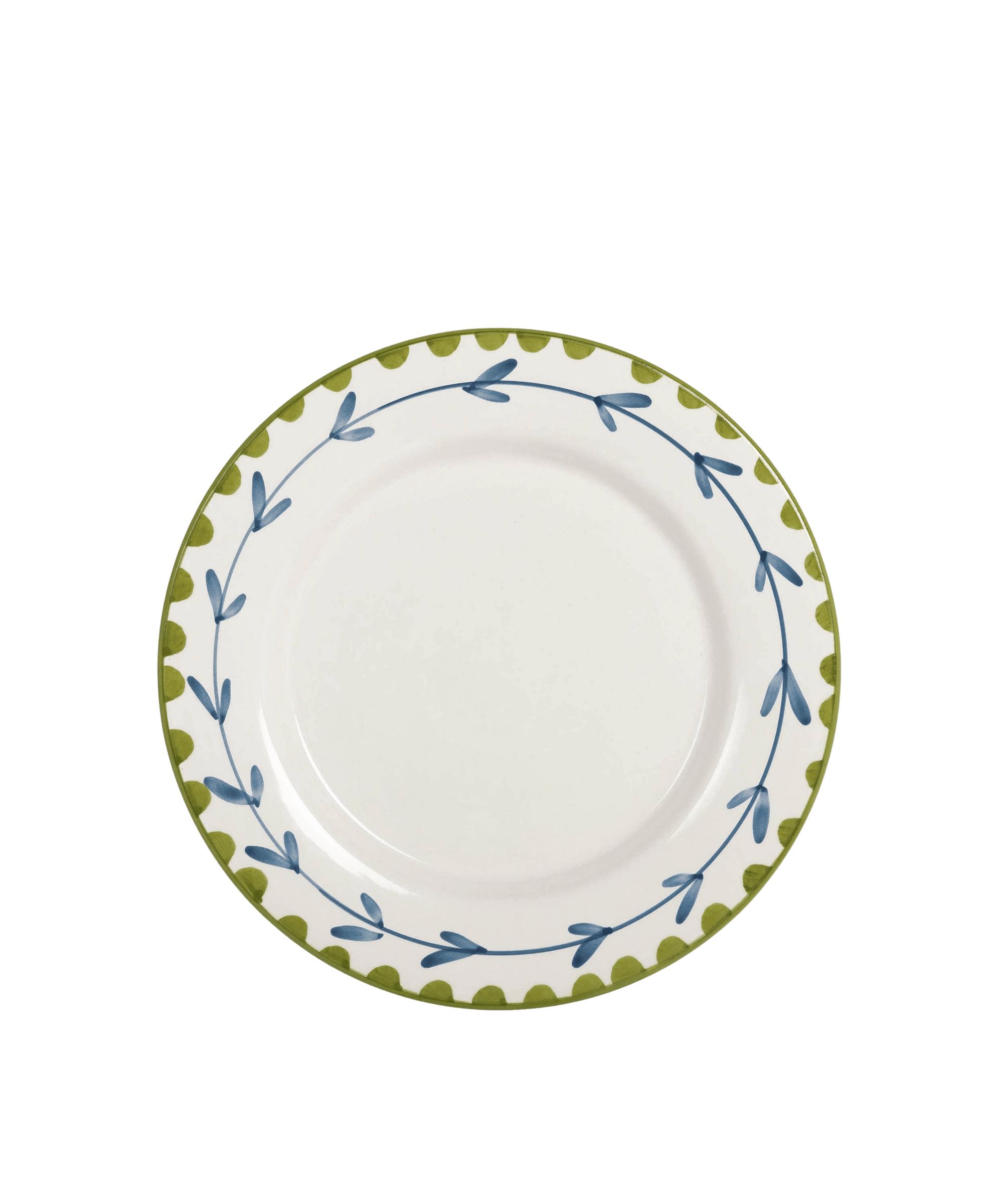 White plate with green and blue decorative rim on a green background