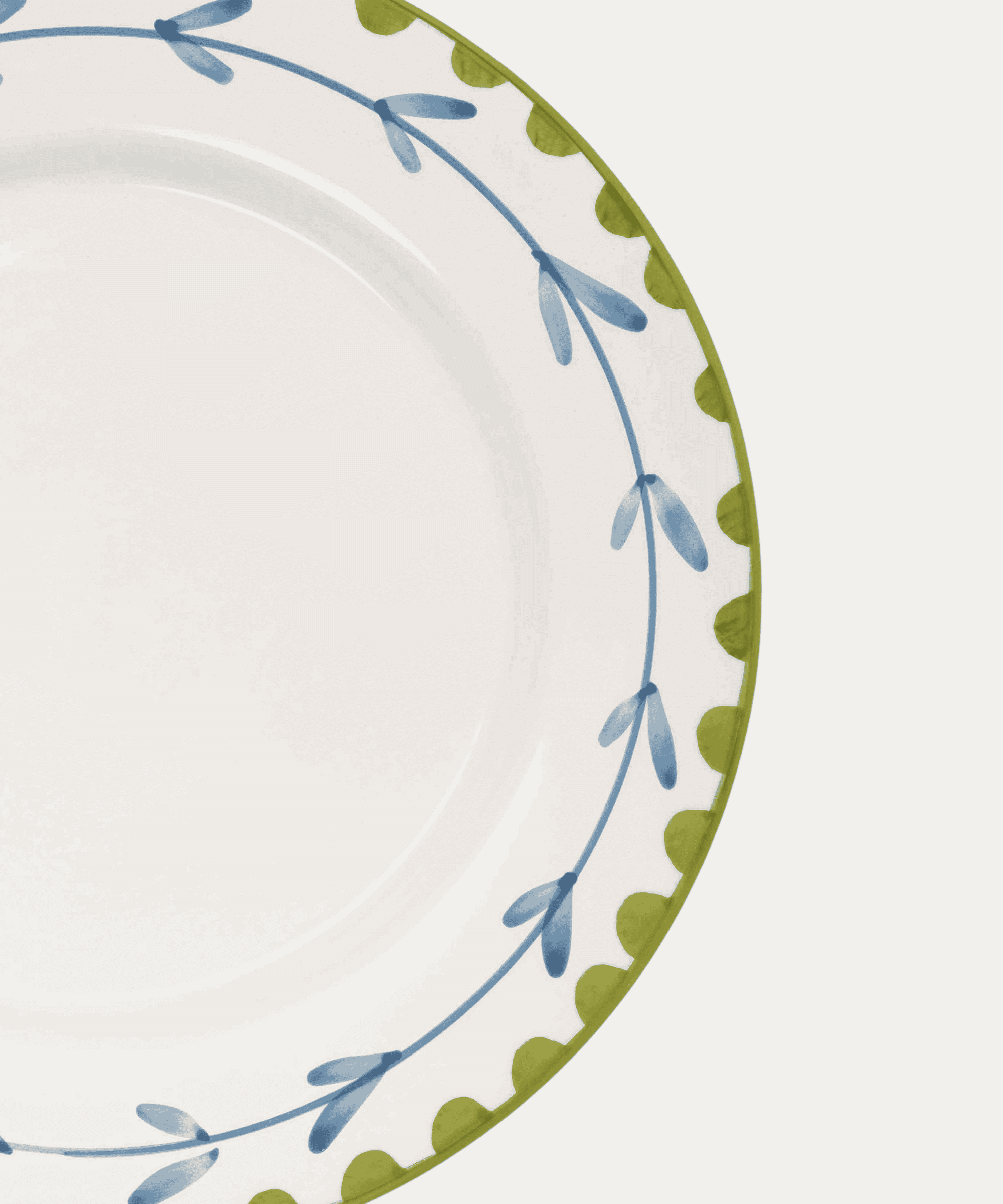 Decorative plate with blue and green floral pattern on a white background