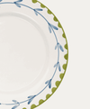Decorative plate with blue and green floral pattern on a white background