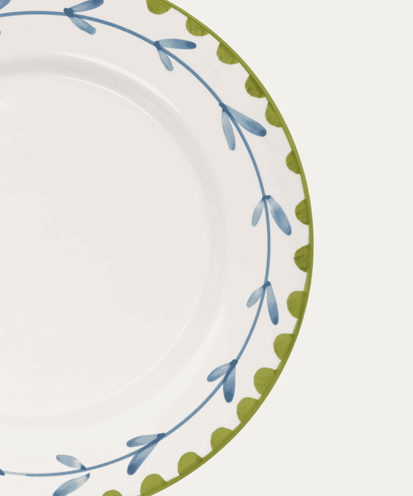 Decorative plate with blue and green floral pattern on a white background