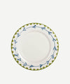 White plate with green and blue decorative rim on a white background