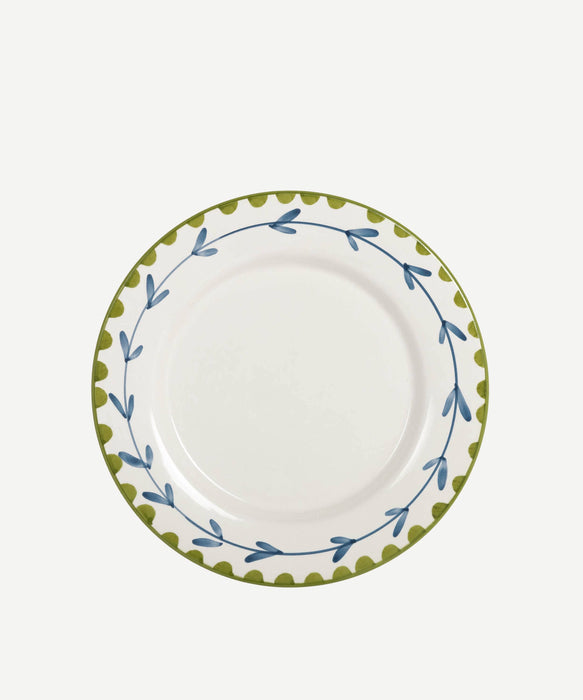White plate with green and blue decorative rim on a white background