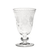 A clear crystal goblet with an etched floral pattern.
