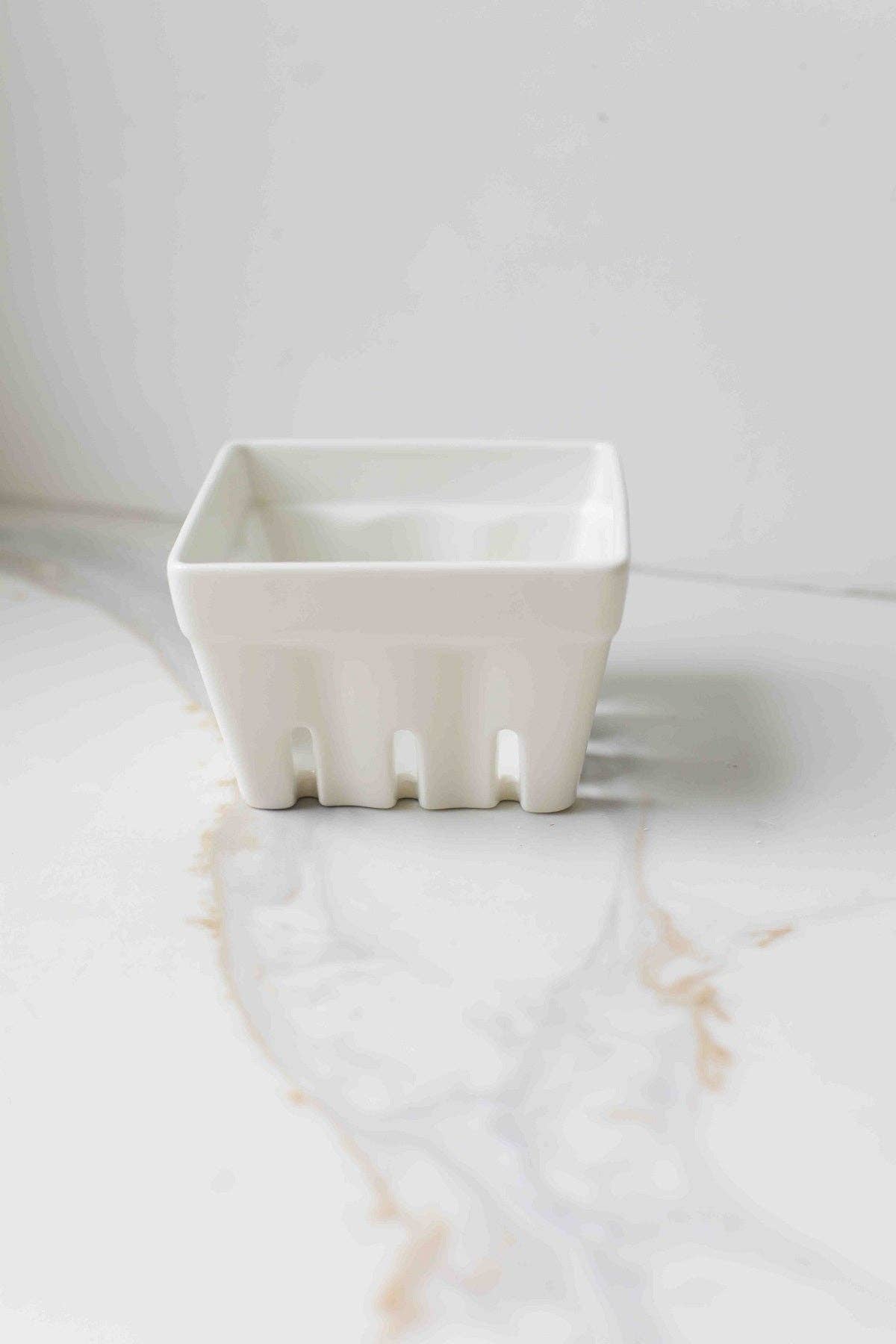 White porcelain berry box collander on white surface 