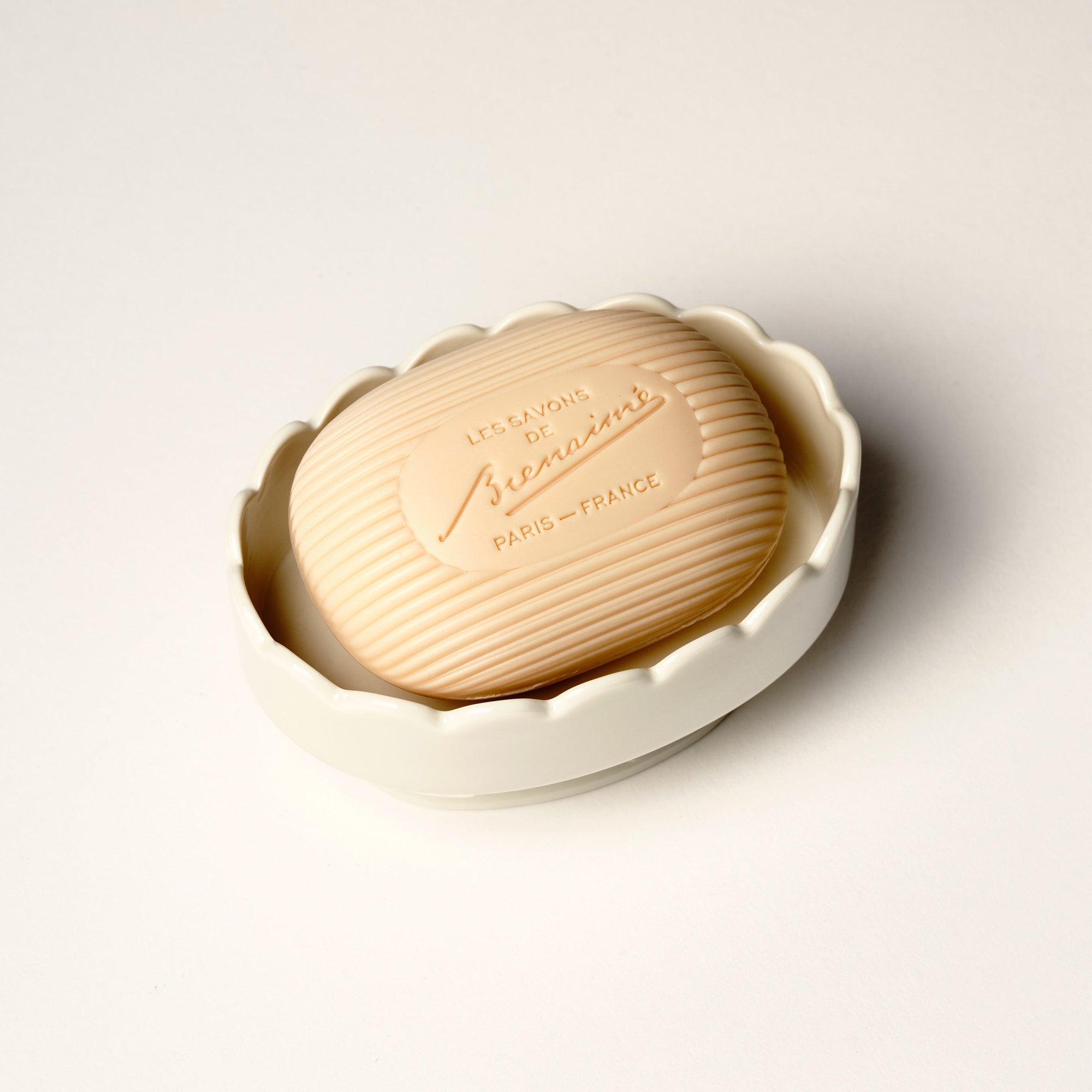 Scalloped edge soap dish with soap on white background