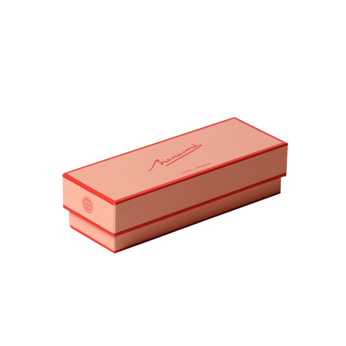 Rectangular pink box with a brand logo on a light beige background
