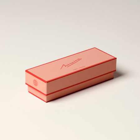 Rectangular pink box with a brand logo on a light beige background