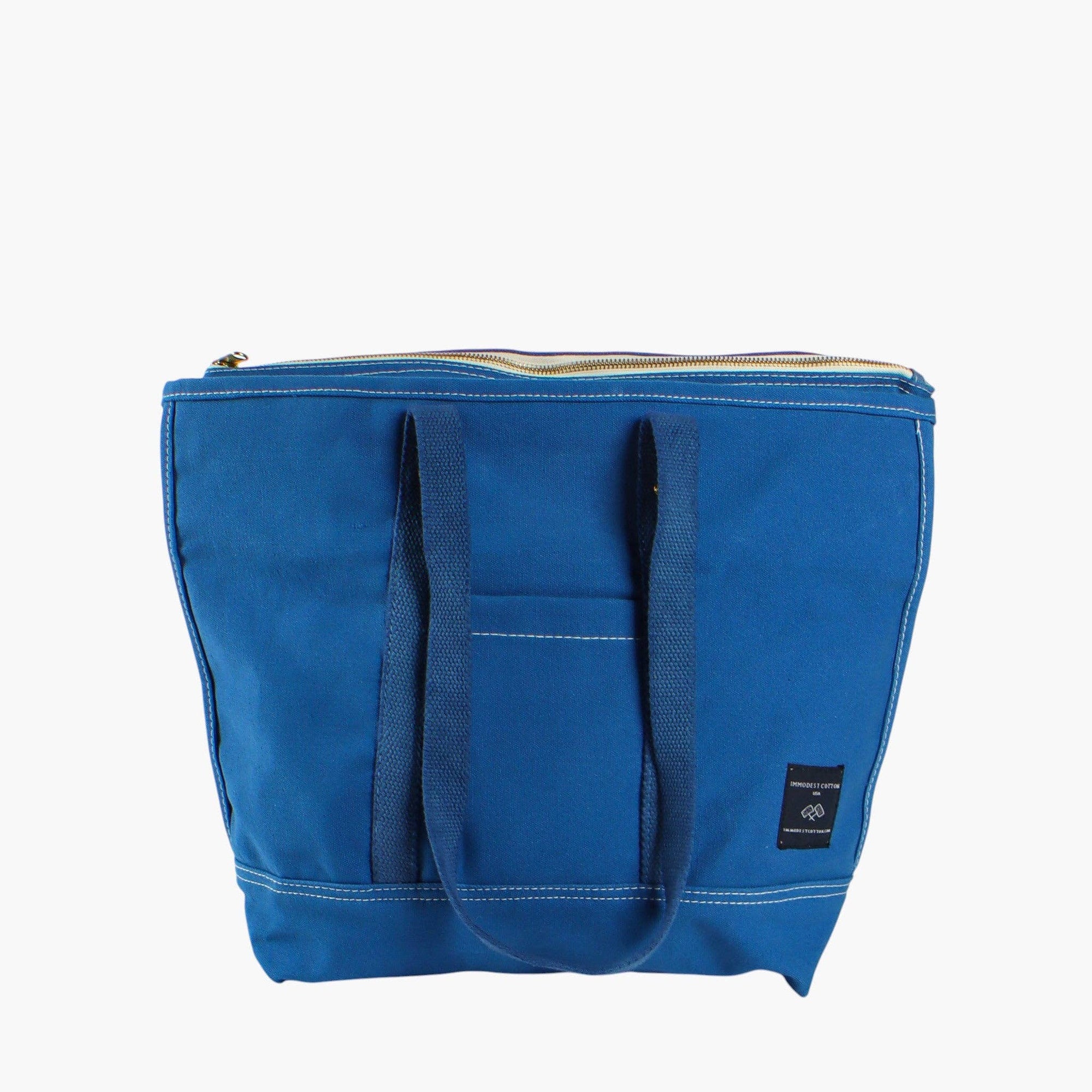 Blue zipper totoe bag with outside pocket on white background 