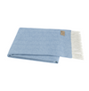 Light blue throw blanket with white fringe on a white background