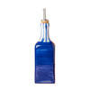 Blue glass bottle with a metal straw on a white background