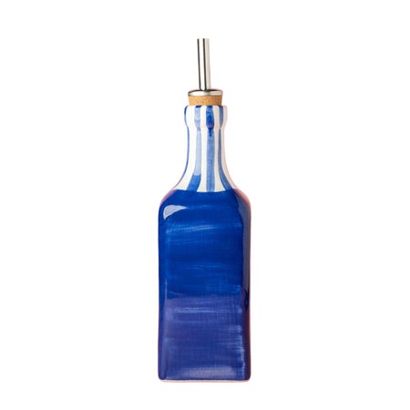 Blue glass bottle with a metal straw on a white background