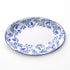 Oval ceramic plate with blue floral pattern on a white background