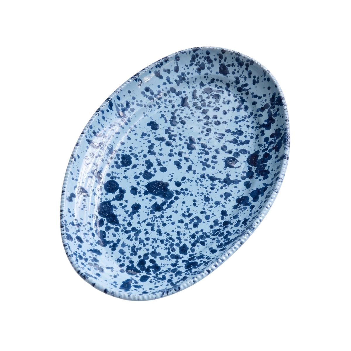 Homeport oval ceramic platter in light blue with dark blue splatter pattern and a decorative textured rim