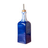 Blue glass bottle with a gold cap on a pink background