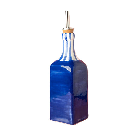 Blue glass bottle with a gold cap on a pink background