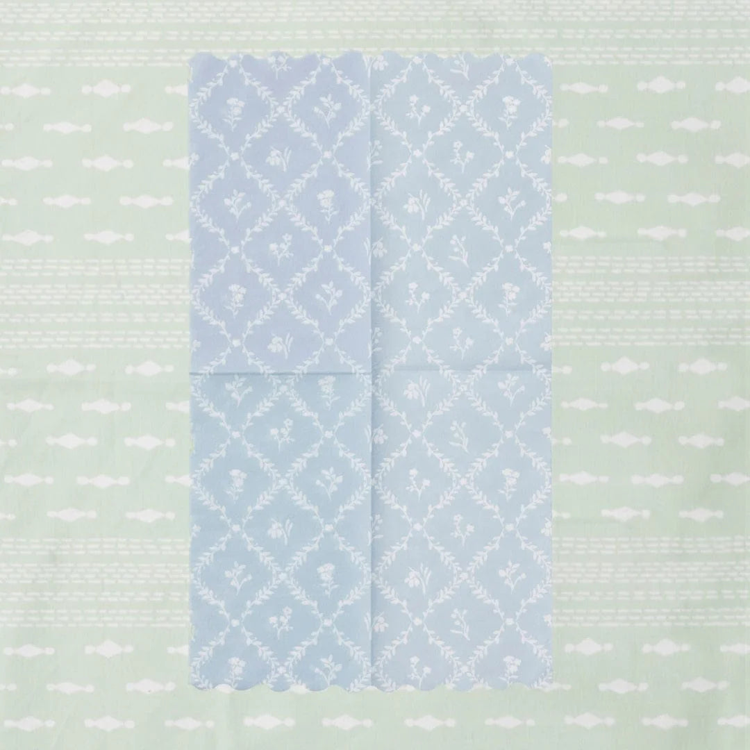 Blue patterned napkin on a textured green background