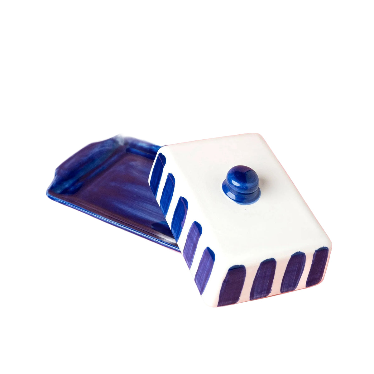 A ceramic blue and white butter dish on white background 