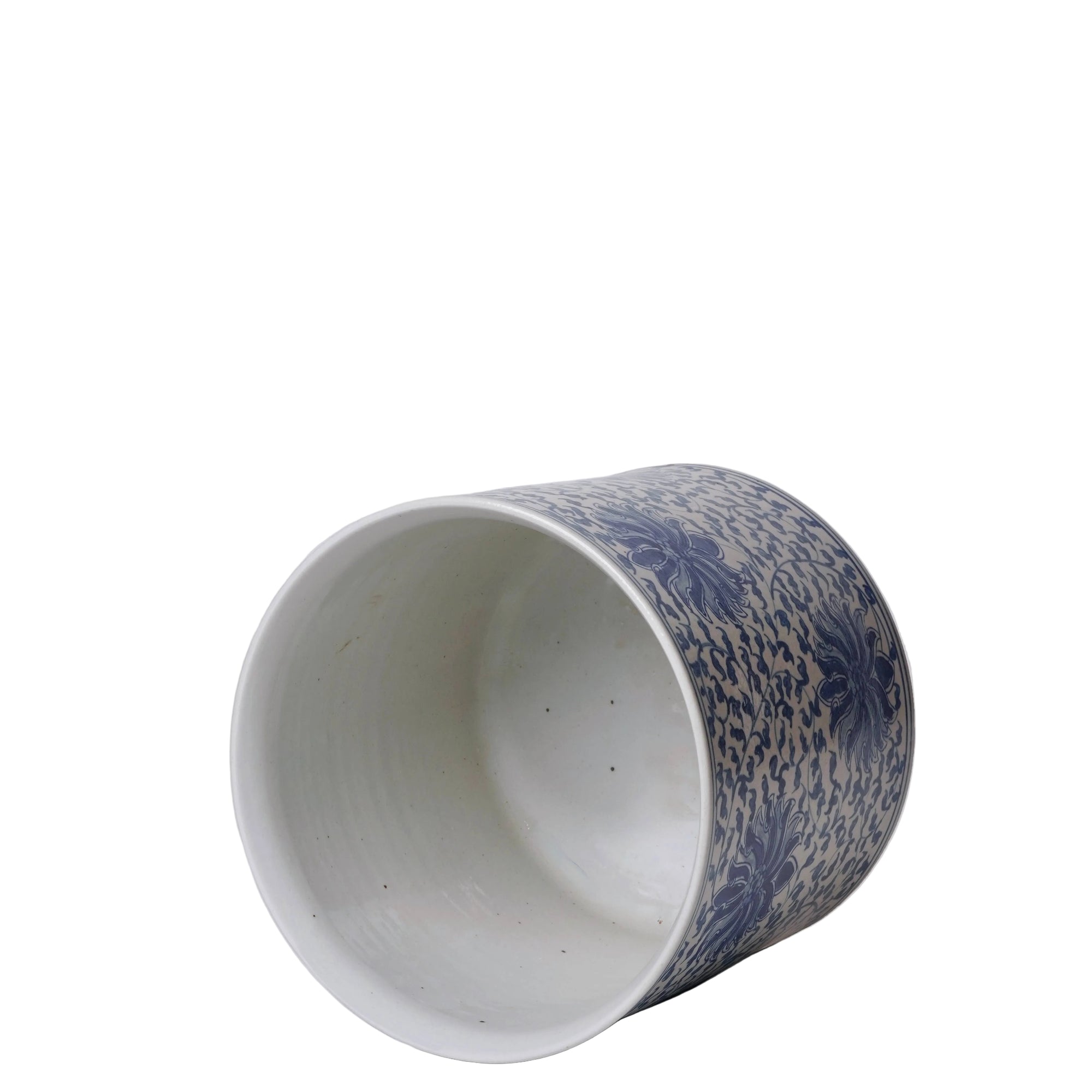 Ceramic cup with blue floral pattern on a white background