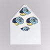 Sticker with caviar design on a white card against a gray background