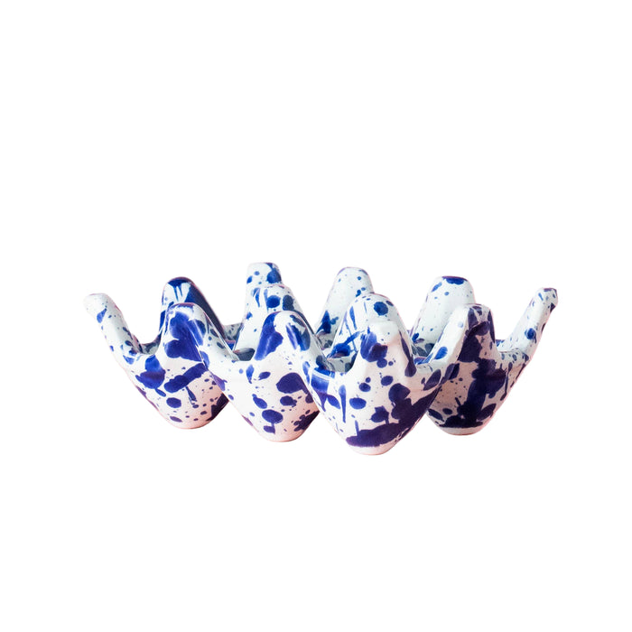 Ceramic egg holder with blue and white splatter-ware 