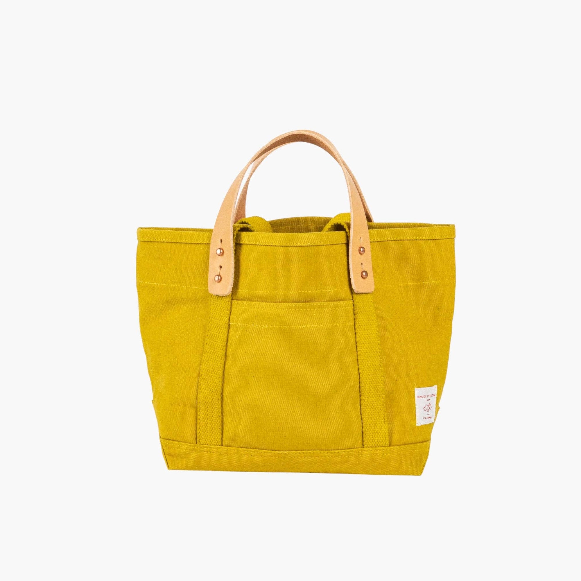 Canvas lunch tote in chartruese with leather handles and outside pocket on white background 