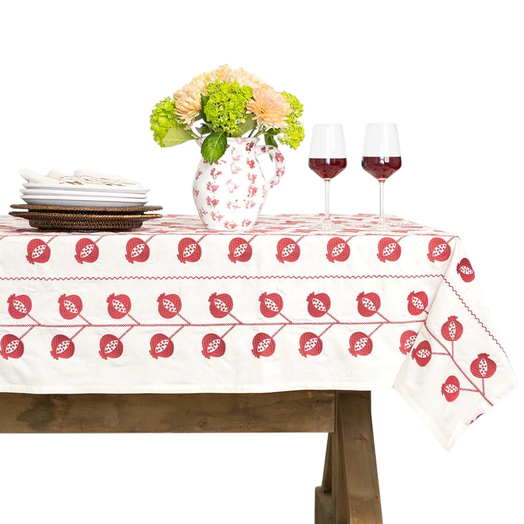 CrewelBurgundy Tablecloth on table with vase.