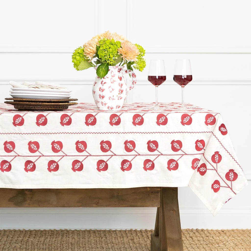 CrewelBurgundy Tablecloth on table with vase. 