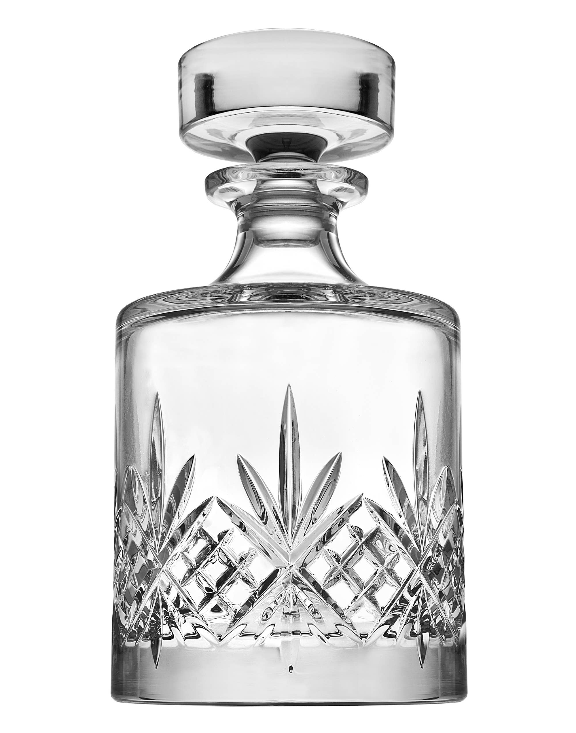 Crystal decanter with intricate cut design on a white background