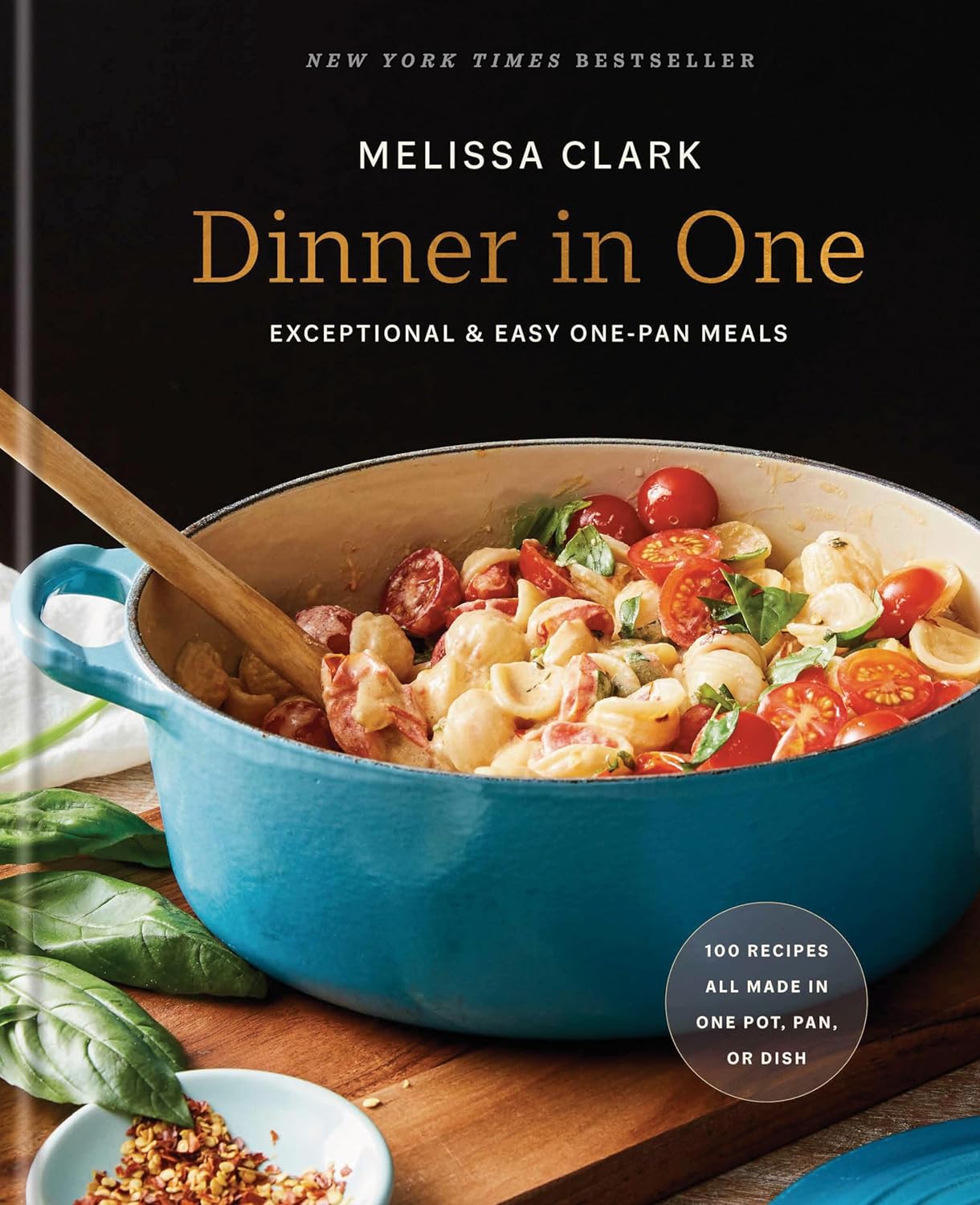 Cover of Dinner in One by Melissa Clark with pot of pasta and tomatoes on a cutting board 