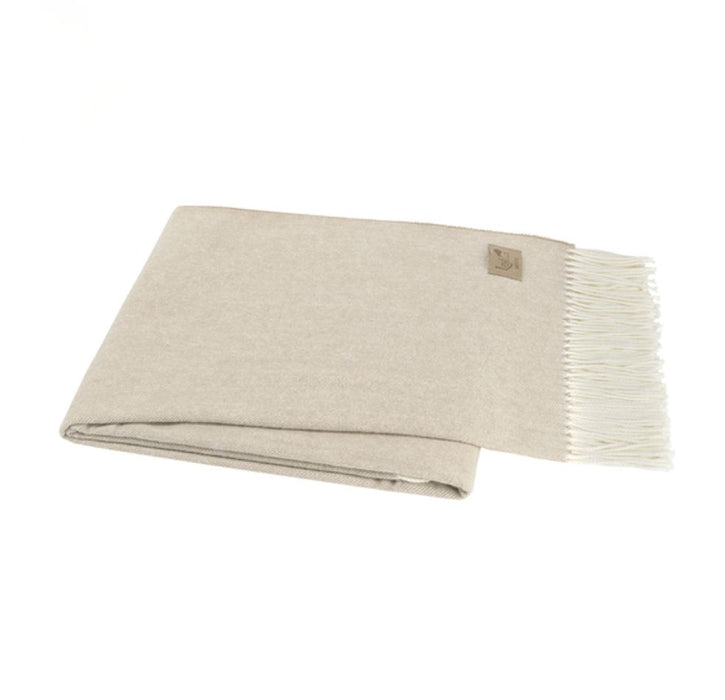 Beige blanket with white fringe on a white background
