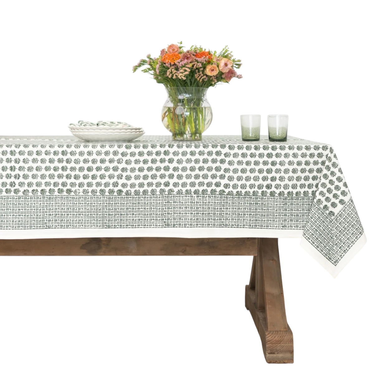 Homeport Elise green cotton tablecloth with hand block printed leafy motifs on a wooden dining table
