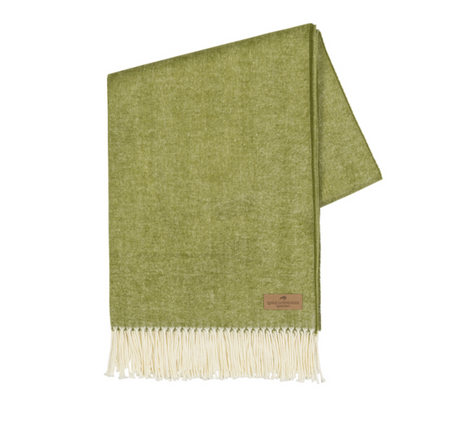 Green throw blanket with white fringe on a white background
