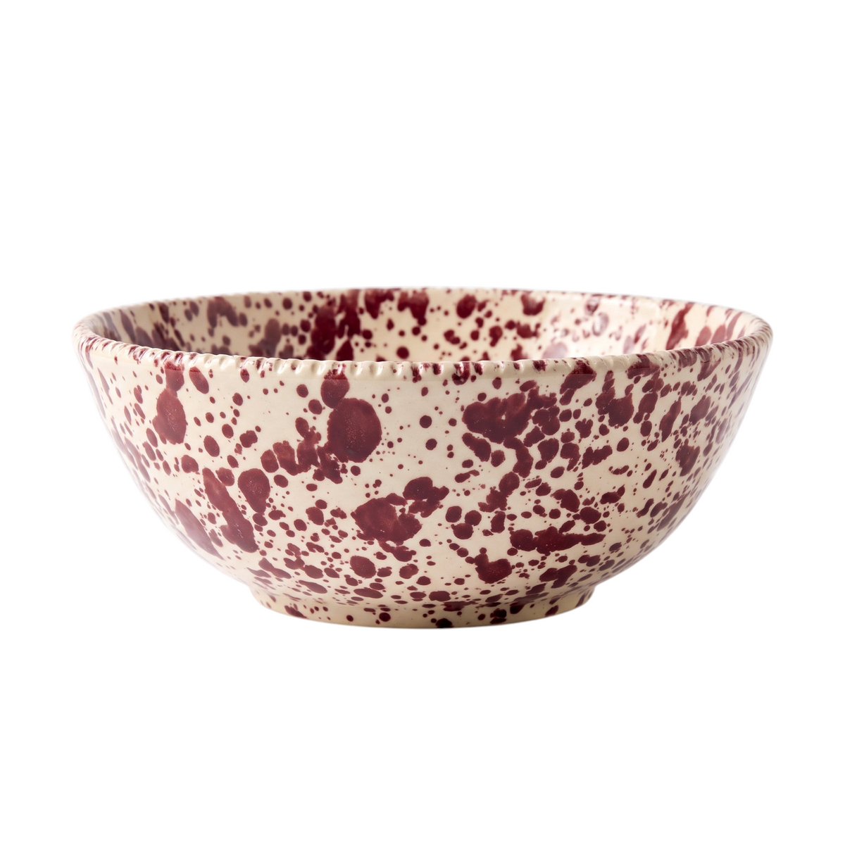 Homeport handmade ceramic serving bowl in cream with a bordeaux red splatter pattern and a textured rim.