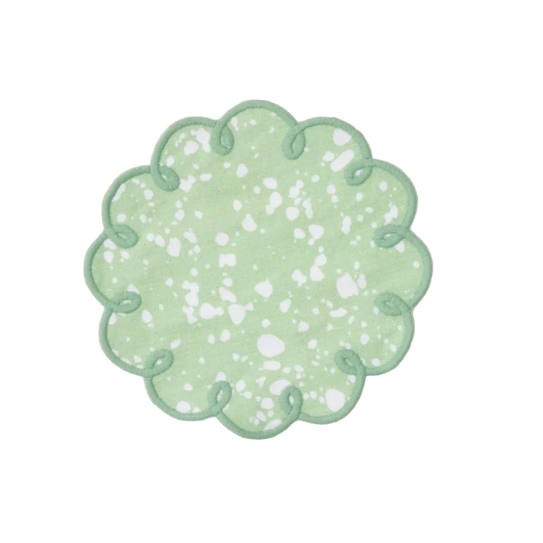 Decorative green patch with floral pattern on a textured fabric background