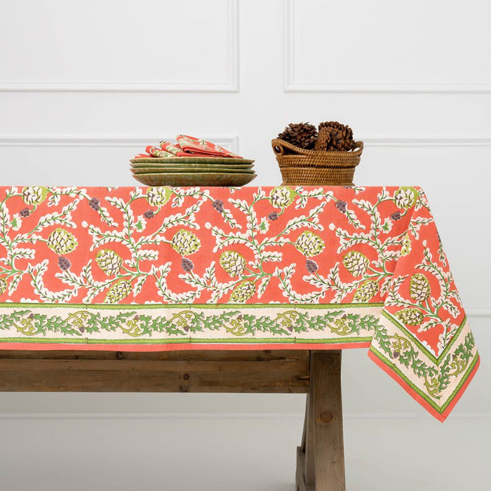Tablecloth with floral pattern on a wooden table against a white wall